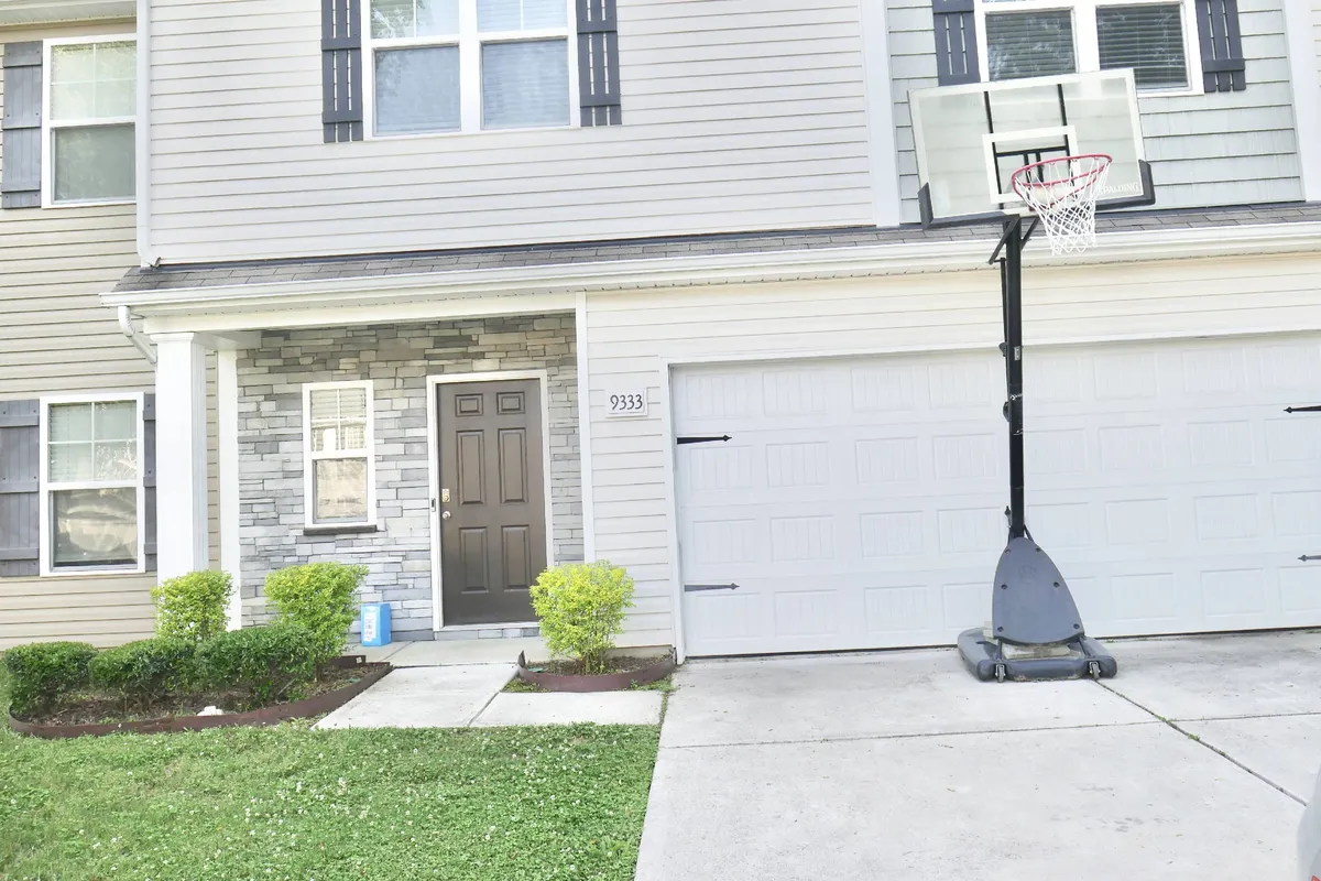 Depicts the front outdoor area with a basketball hoop mounted above a garage door. The scene includes children playing basketball and friends gathering, evoking a lively, family-friendly environment.